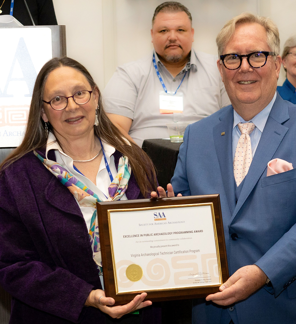 Dr. Carole Nash receives the Society for American Archaeology's Excellence in Public Archaeology Programing Award from Dr. Christopher Dore, SAA President.