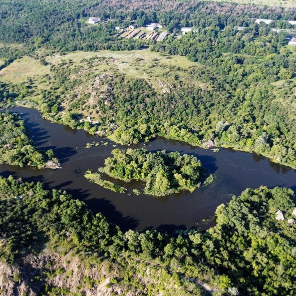 Winding river through a mountain valley, representing the New River landscape in Virginia